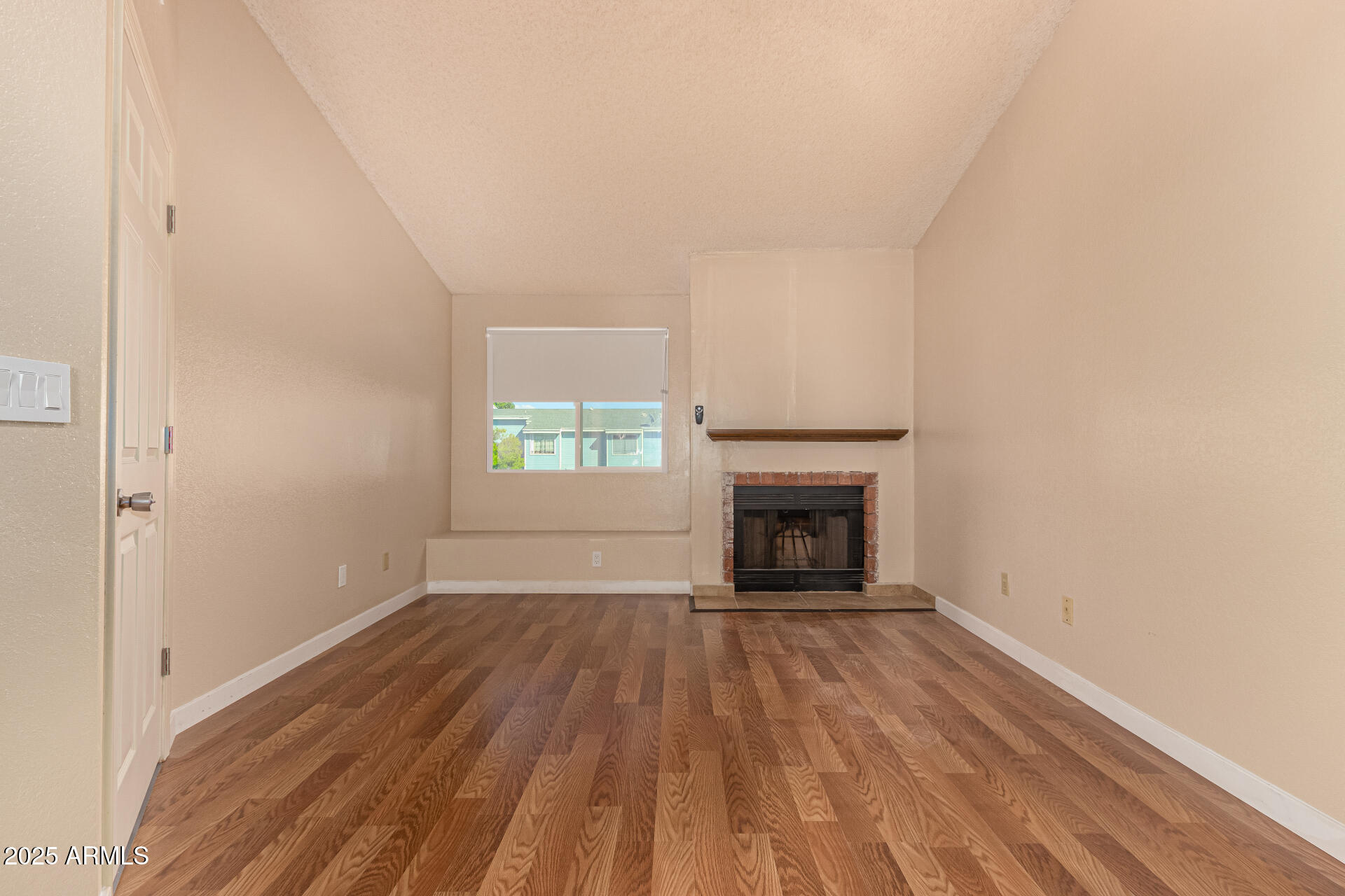 510 North Alma School Road, Unit 159 Mesa, AZ 85201 - Photo 15 of 36 a view of an empty room with a fireplace and a window