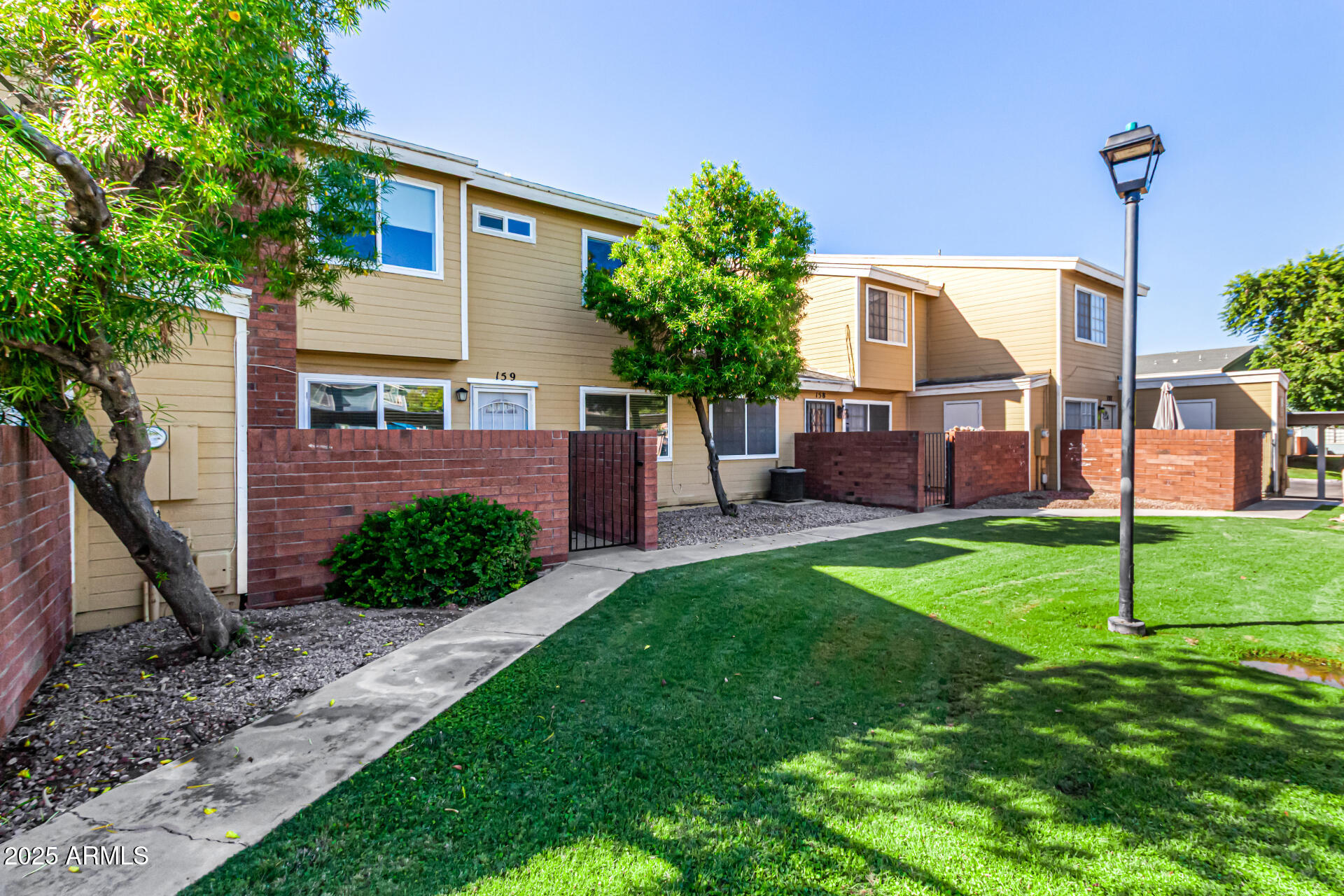 510 North Alma School Road, Unit 159 Mesa, AZ 85201 - Photo 3 of 36 a front view of a house with garden