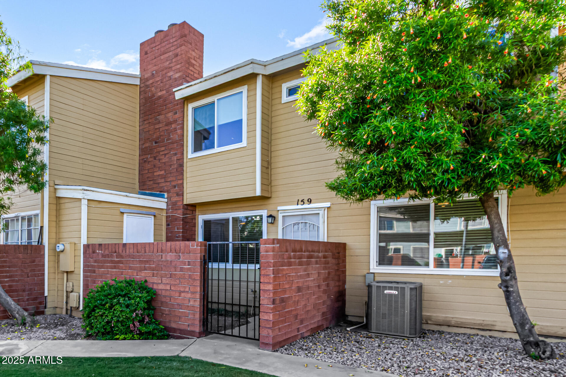510 North Alma School Road, Unit 159 Mesa, AZ 85201 - Photo 6 of 36 a view of a house with a yard and roof deck