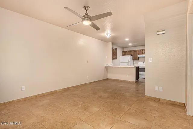 a view of a kitchen with a sink and a refrigerator