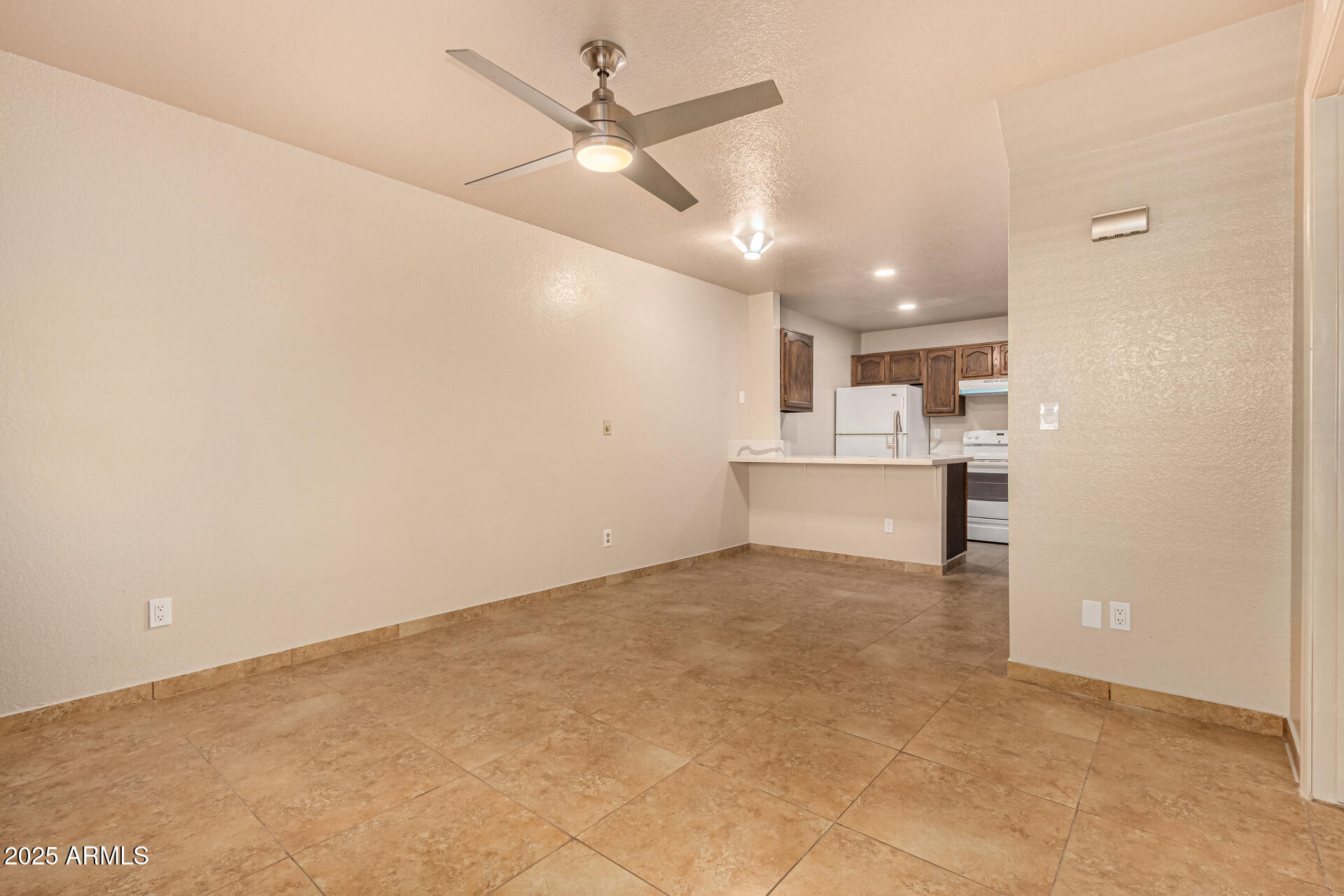 510 North Alma School Road, Unit 159 Mesa, AZ 85201 - Photo 9 of 36 a view of a kitchen with a sink and a refrigerator