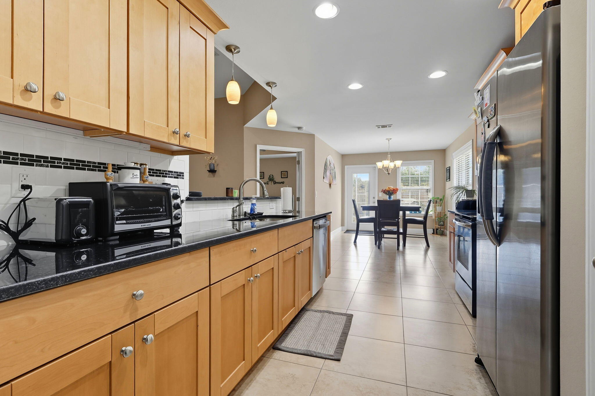 219 January Court Crestview, FL 32539 - Photo 11 of 37 a kitchen with stainless steel appliances granite countertop a refrigerator a stove and a sink