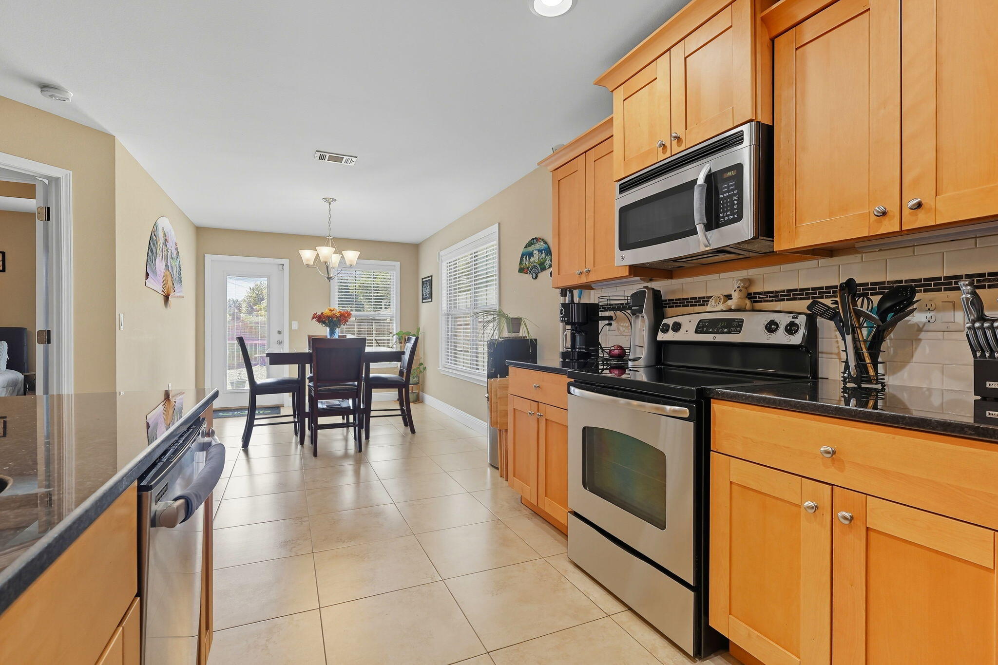 219 January Court Crestview, FL 32539 - Photo 13 of 37 a kitchen with stainless steel appliances granite countertop a stove a sink and a microwave