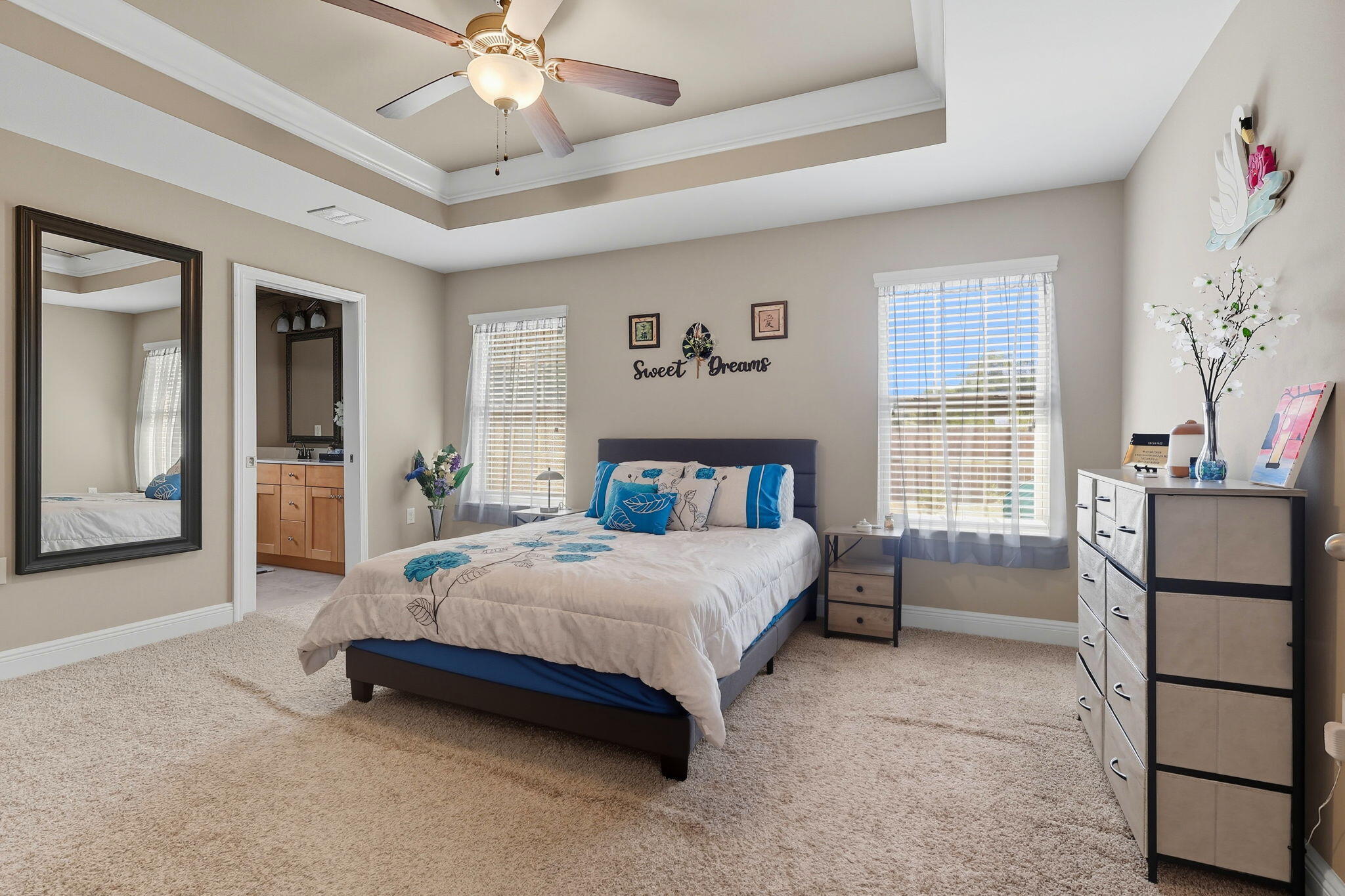 219 January Court Crestview, FL 32539 - Photo 16 of 37 a spacious bedroom with a bed and a chandelier