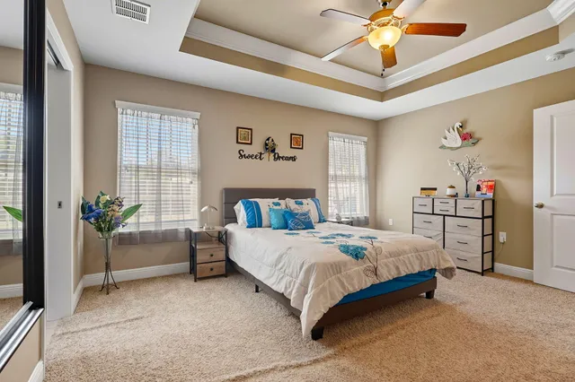 a bedroom with a bed and a chandelier