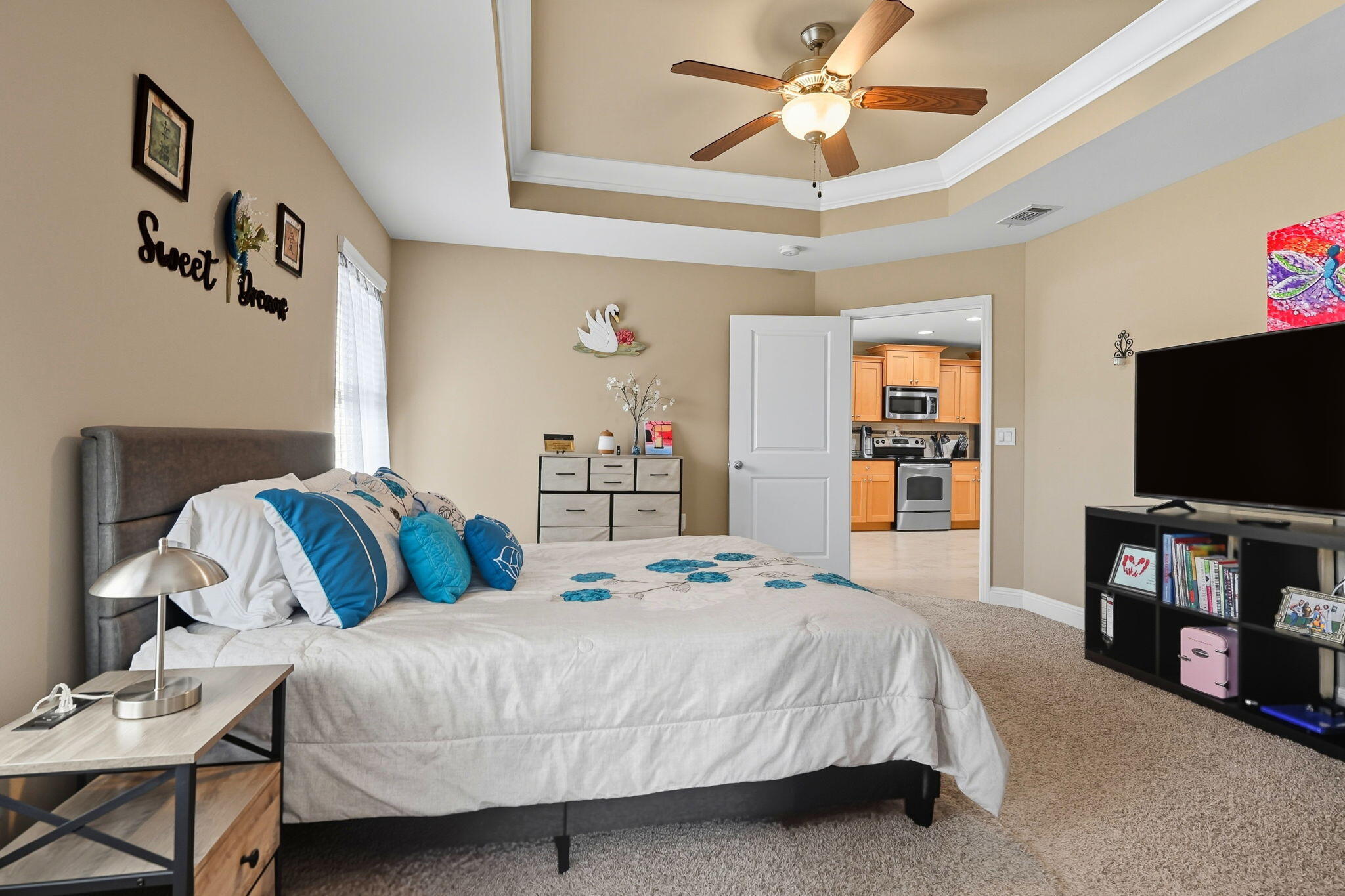 219 January Court Crestview, FL 32539 - Photo 18 of 37 a bedroom with a bed a flat screen tv and a chandelier