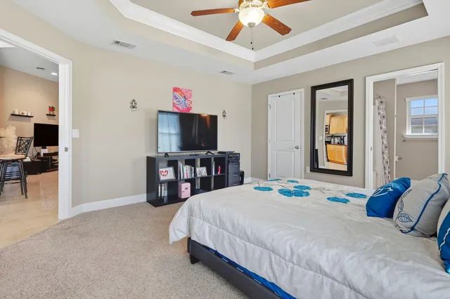 a bedroom with a bed and a flat screen television