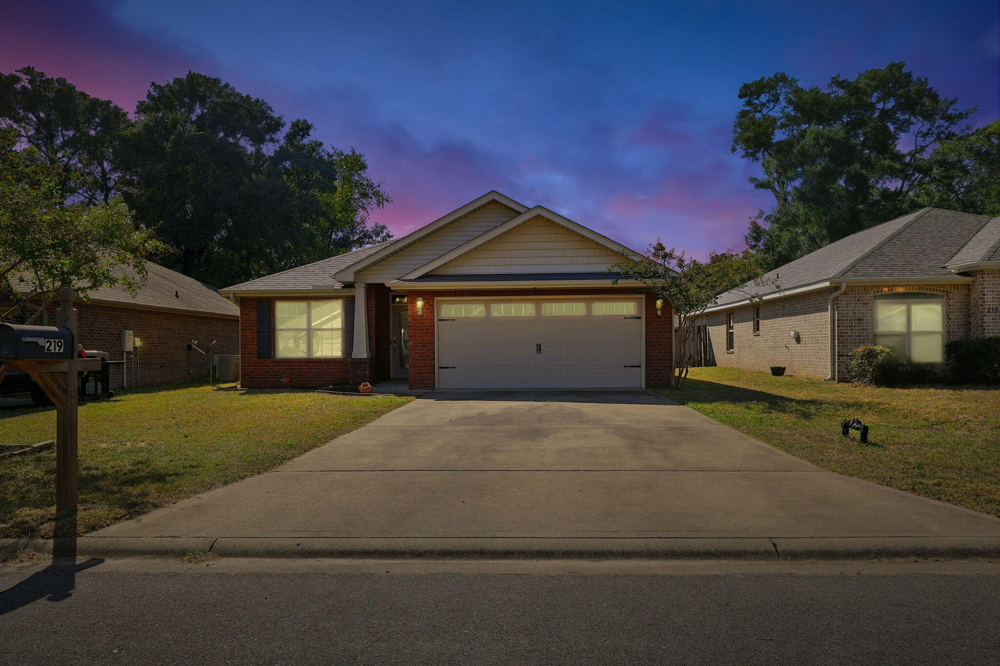 219 January Court Crestview, FL 32539 - Photo 2 of 37 a front view of a house with a yard and garage
