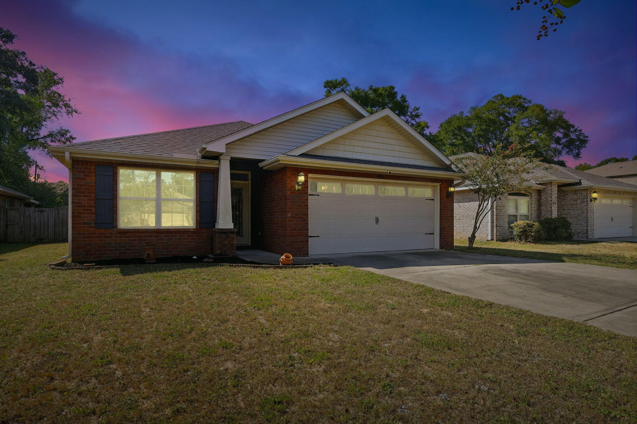 219 January Court Crestview, FL 32539 - Photo 3 of 37 a view of a house with a yard and garage