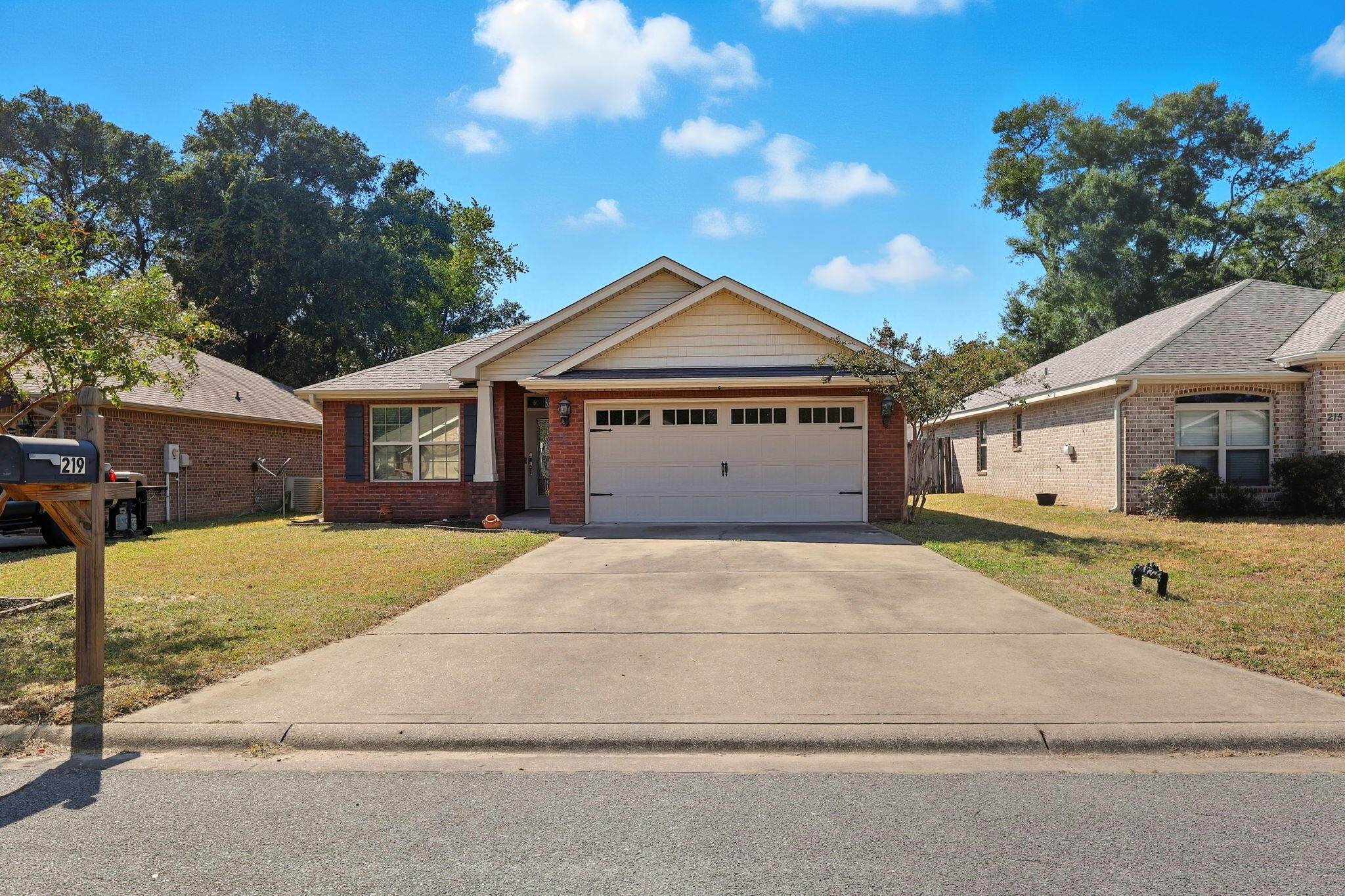 219 January Court Crestview, FL 32539 - Photo 4 of 37 a front view of a house with a yard and garage