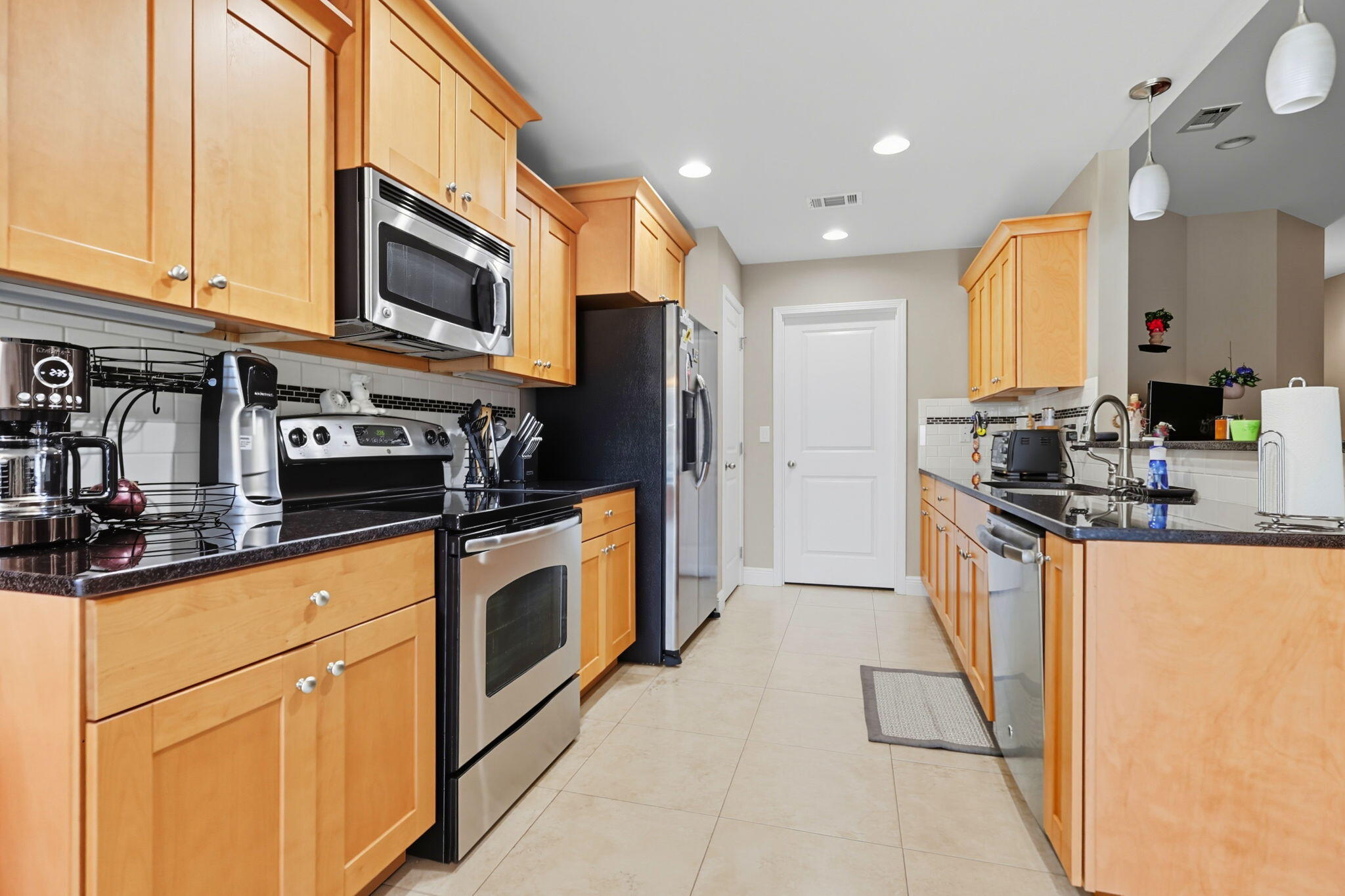 219 January Court Crestview, FL 32539 - Photo 10 of 37 a kitchen with stainless steel appliances granite countertop a stove a sink and a microwave