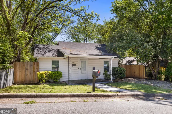 a view of a house with a yard and tree s