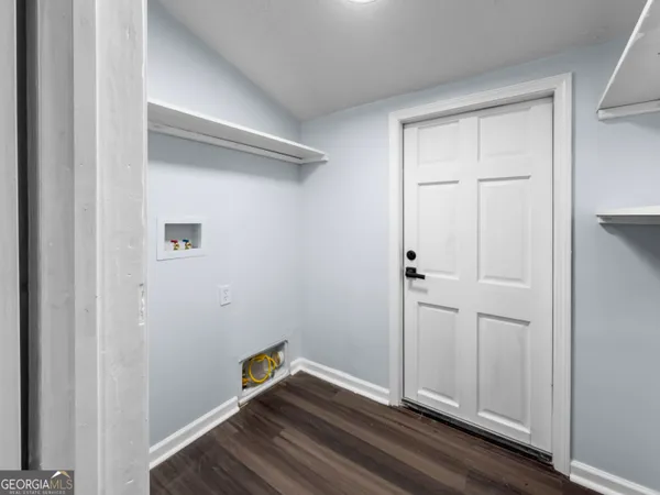 a view of room with wooden floor