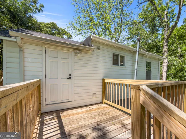 a view of a house with a wooden deck