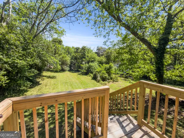 a view of a balcony with wooden floor and fence