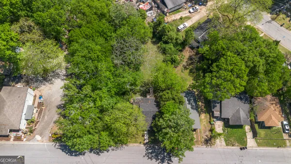 an aerial view of a house with yard and outdoor seating