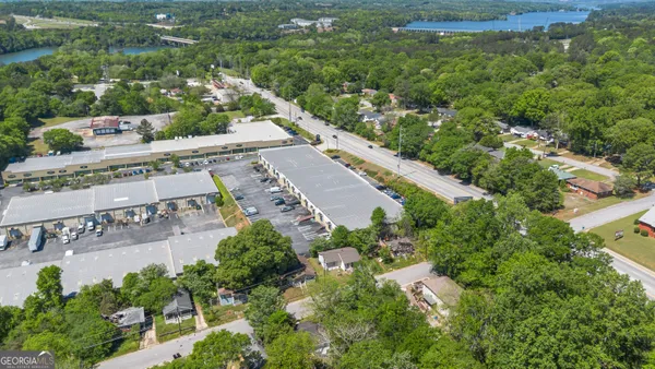 an aerial view of residential houses with outdoor space and trees