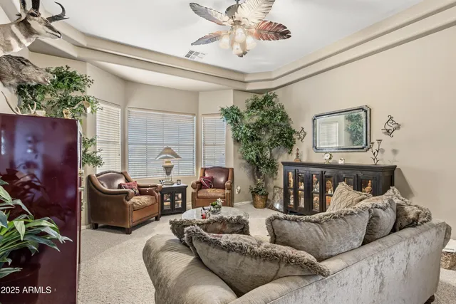 a kitchen with stainless steel appliances granite countertop a refrigerator a sink dishwasher a dining table and chairs with wooden floor