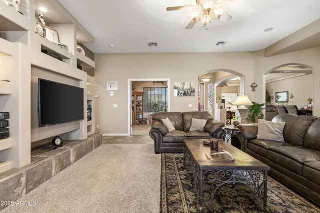 a bedroom with a bed furniture and a flat tv screen