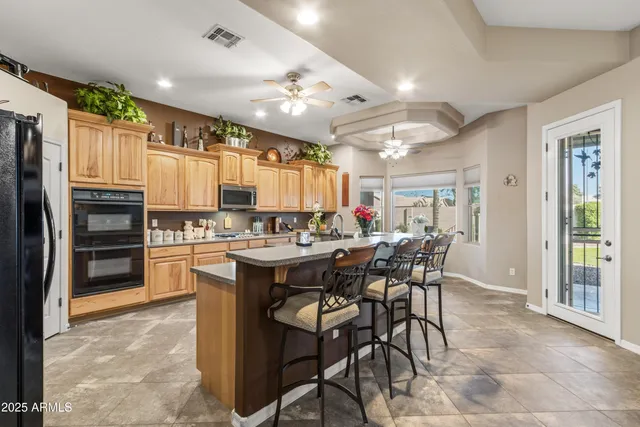 a bathroom with a double vanity sink a mirror and a toilet