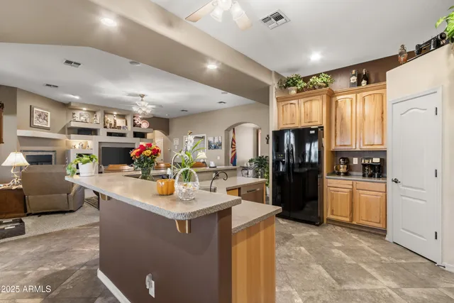 a bedroom with a bed and a large mirror on the dresser