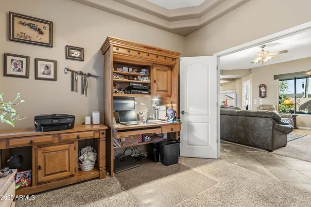 a balcony with chairs and a potted plant