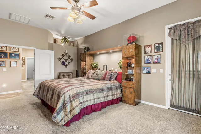 a view of a house with a yard and potted plants