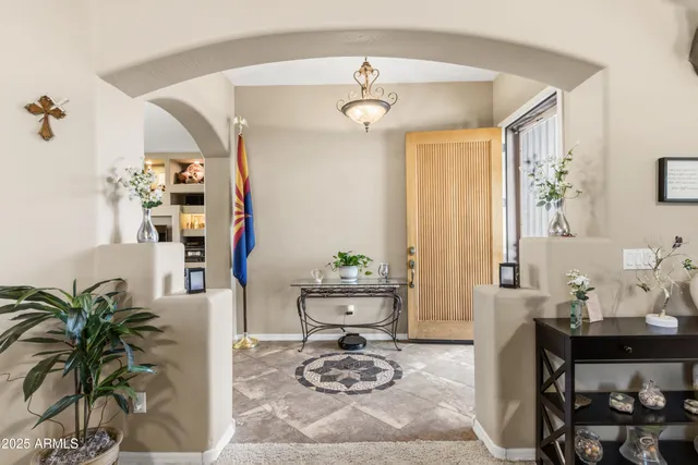 a living room with furniture fireplace and a large window
