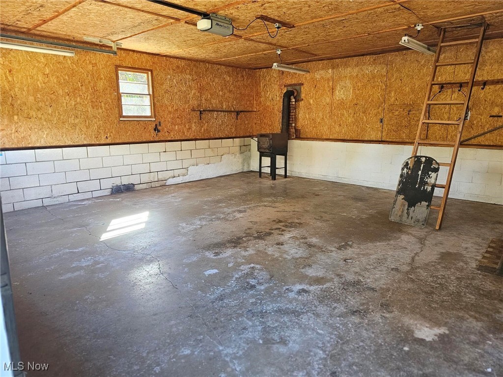 8125 Scio Road Scio, OH 43988 - Photo 12 of 16 Garage with concrete block wall and a garage door opener