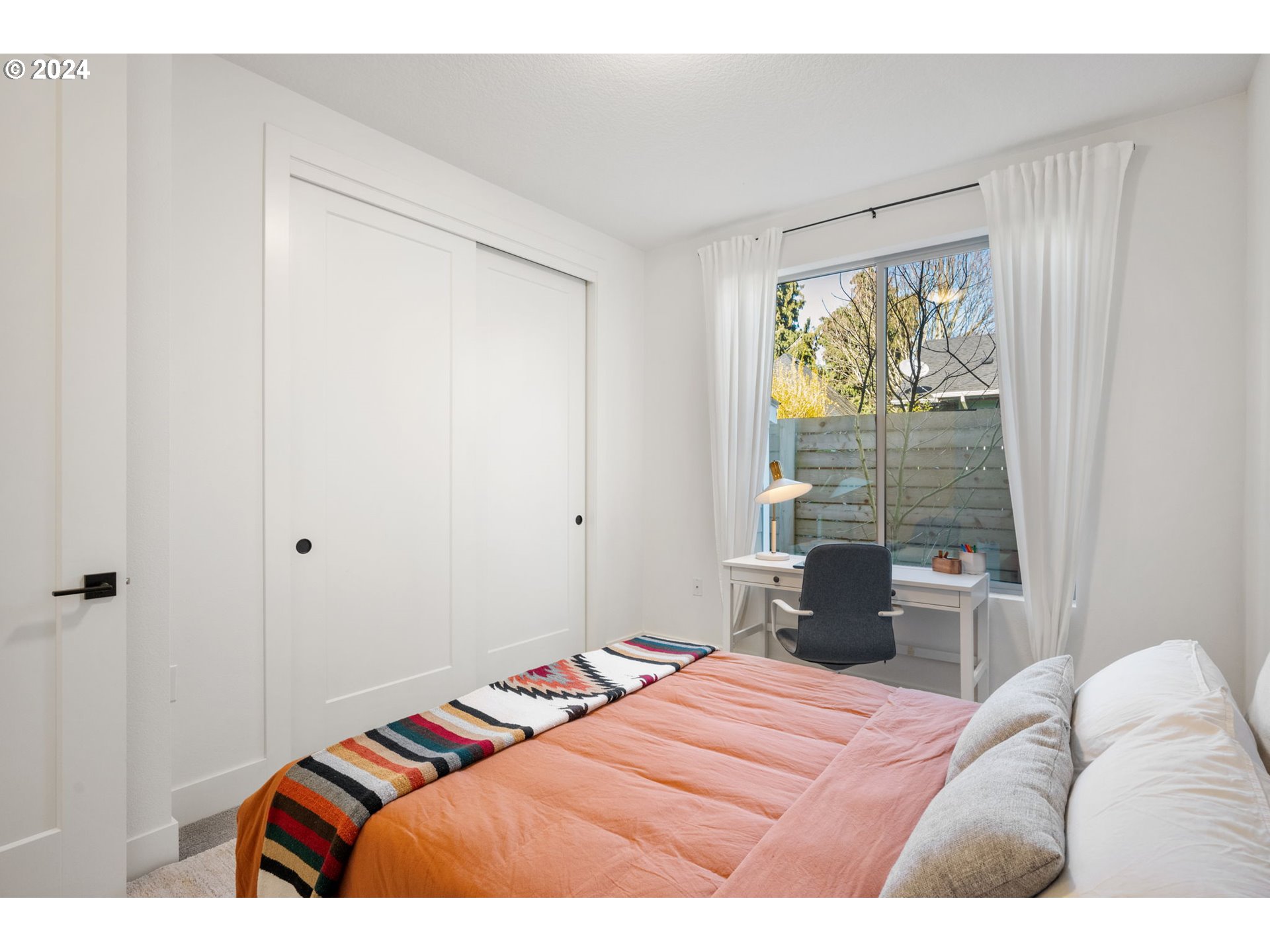1616 Northeast 45th Avenue, Unit 1 Portland, OR 97213 - Photo 15 of 30 a bedroom with a bed and a window