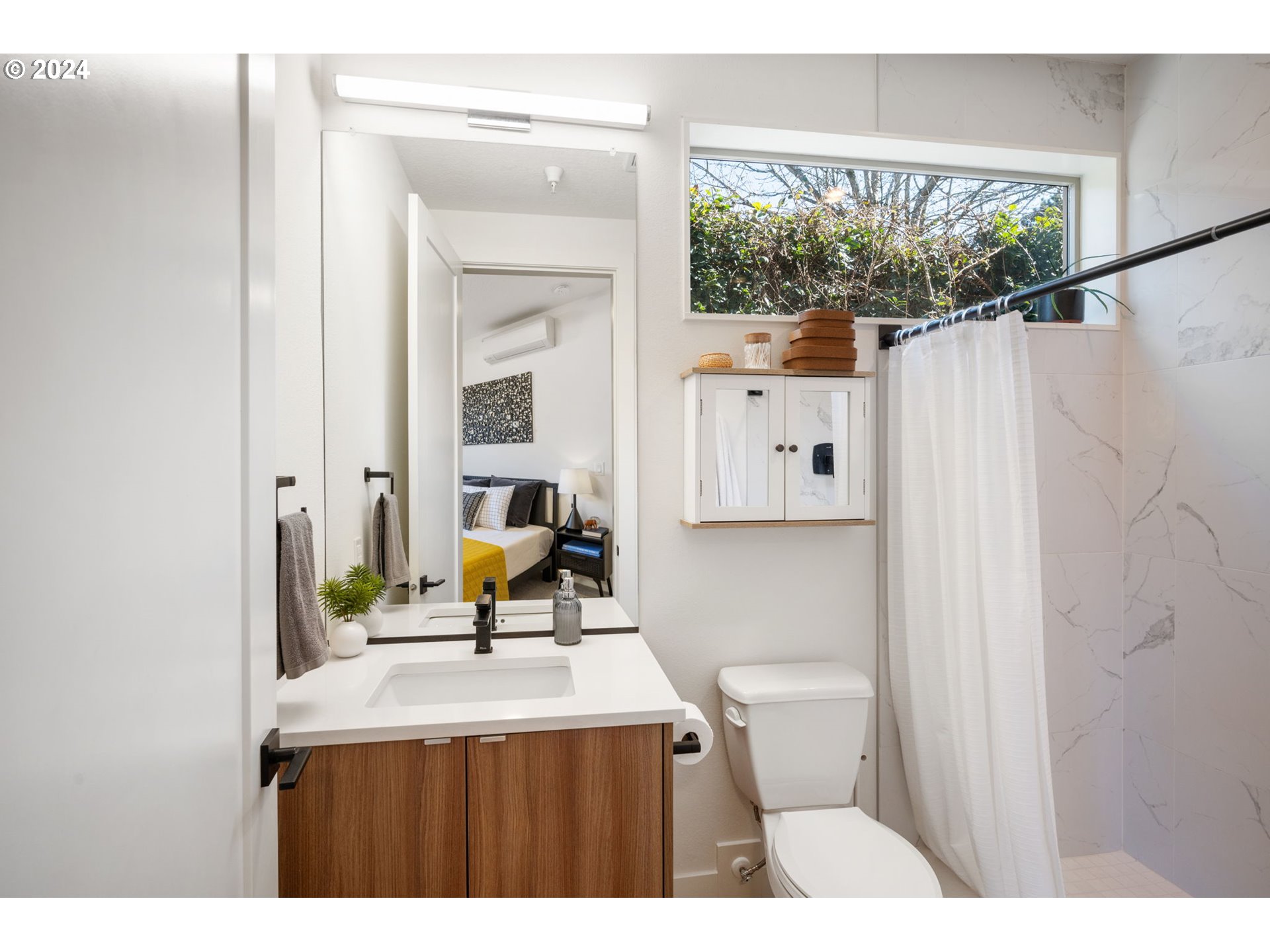 1616 Northeast 45th Avenue, Unit 1 Portland, OR 97213 - Photo 19 of 30 a view of a bathroom with a sink and a mirror