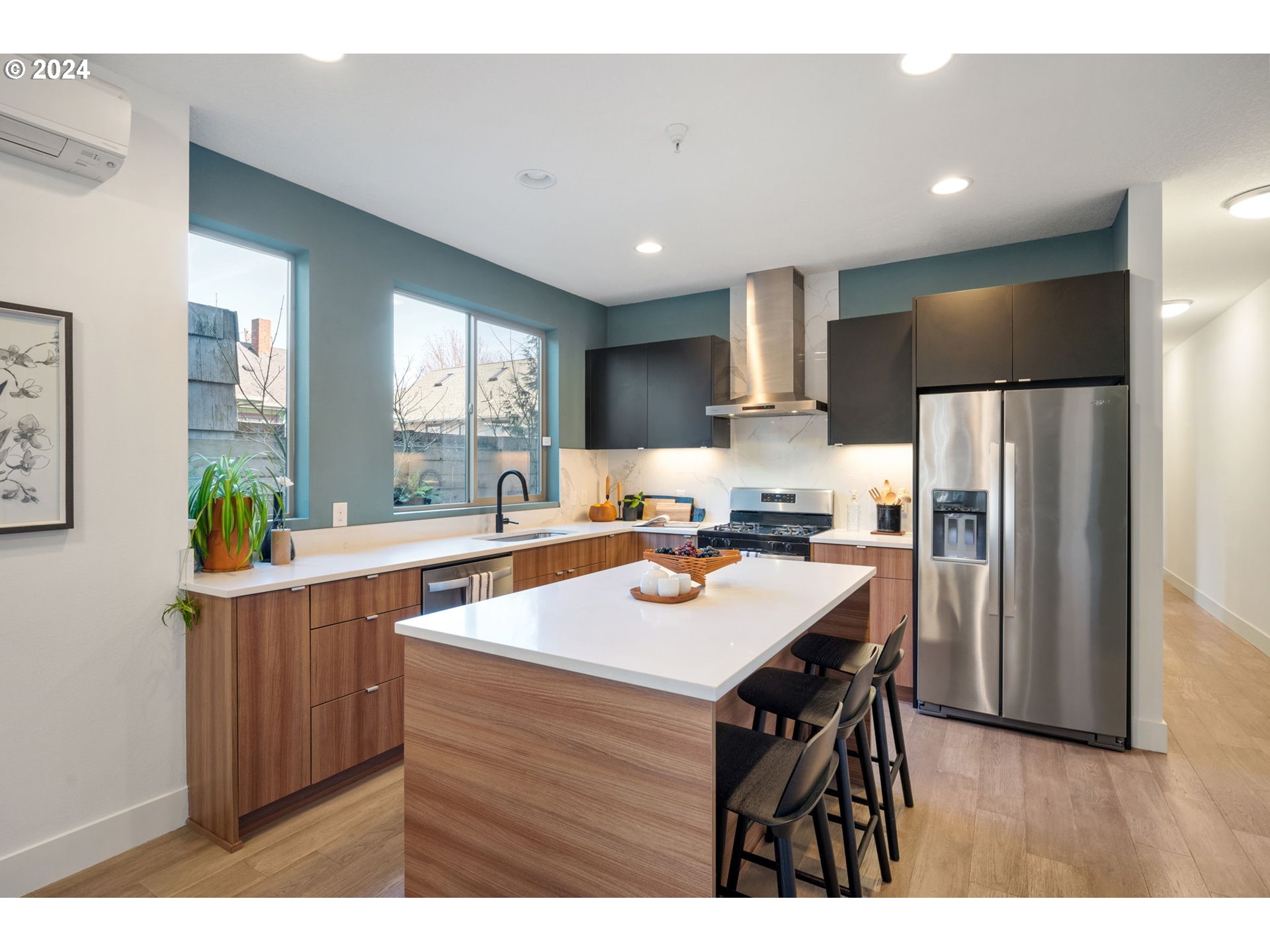 1616 Northeast 45th Avenue, Unit 1 Portland, OR 97213 - Photo 8 of 30 a kitchen with kitchen island a sink stove and refrigerator