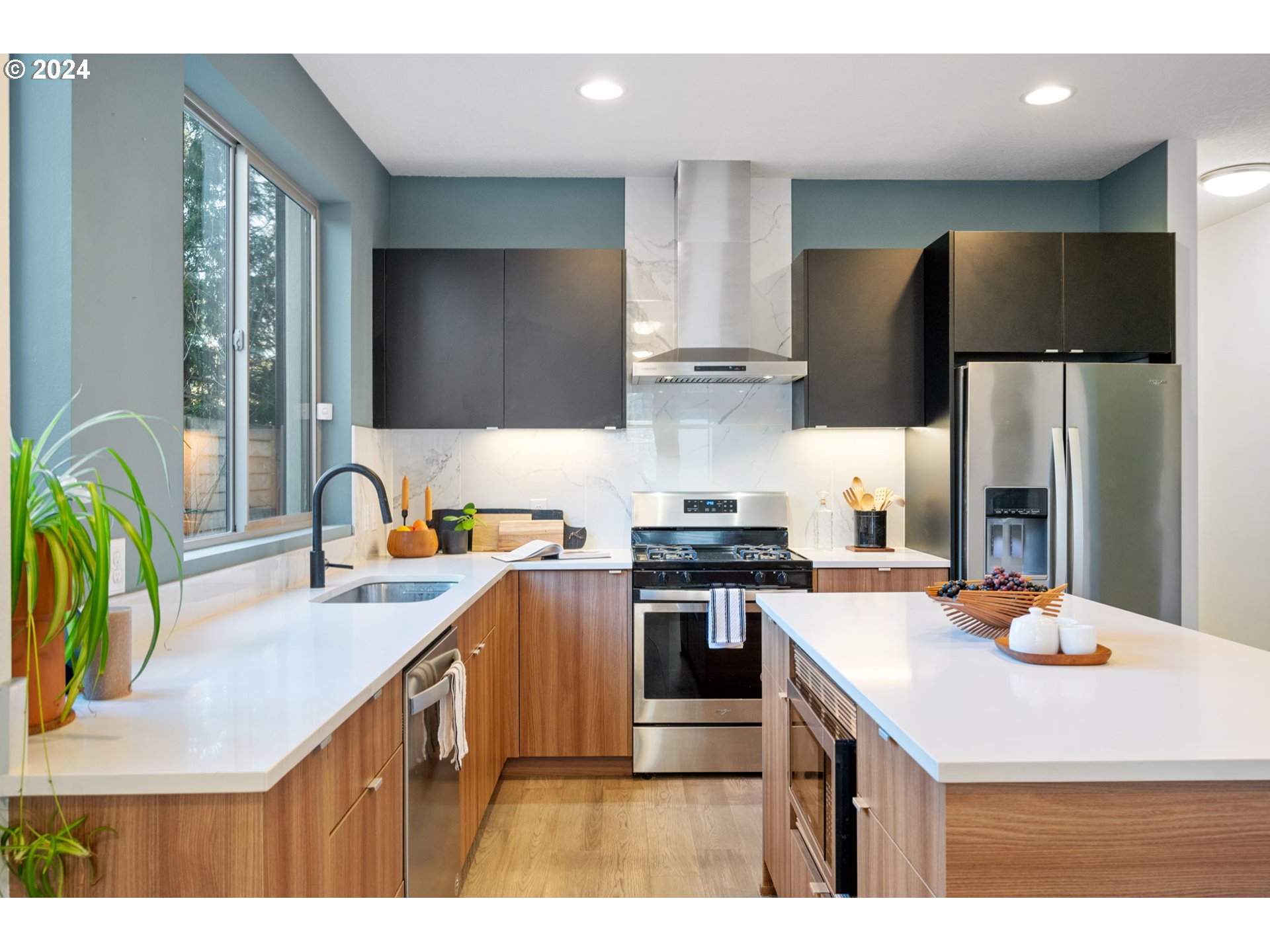 1616 Northeast 45th Avenue, Unit 1 Portland, OR 97213 - Photo 9 of 30 a kitchen with stainless steel appliances a stove a sink a refrigerator and a refrigerator