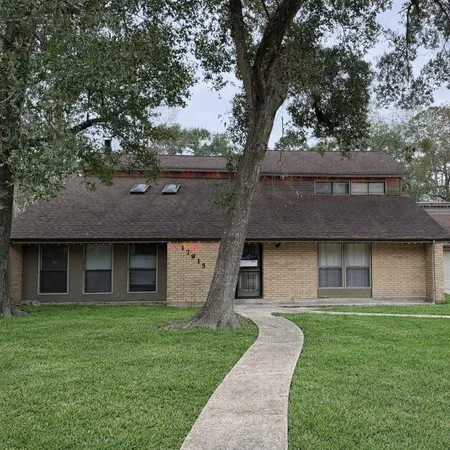 a front view of a house with a garden and yard