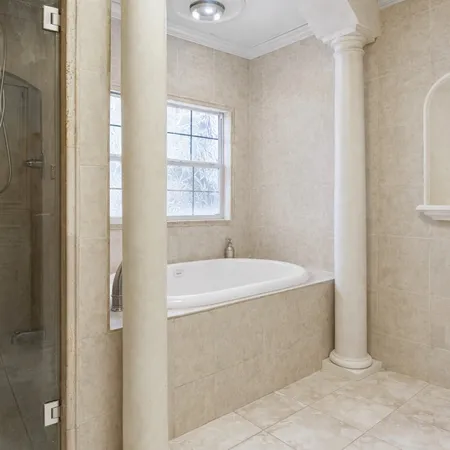 a white bath tub sitting next to a window
