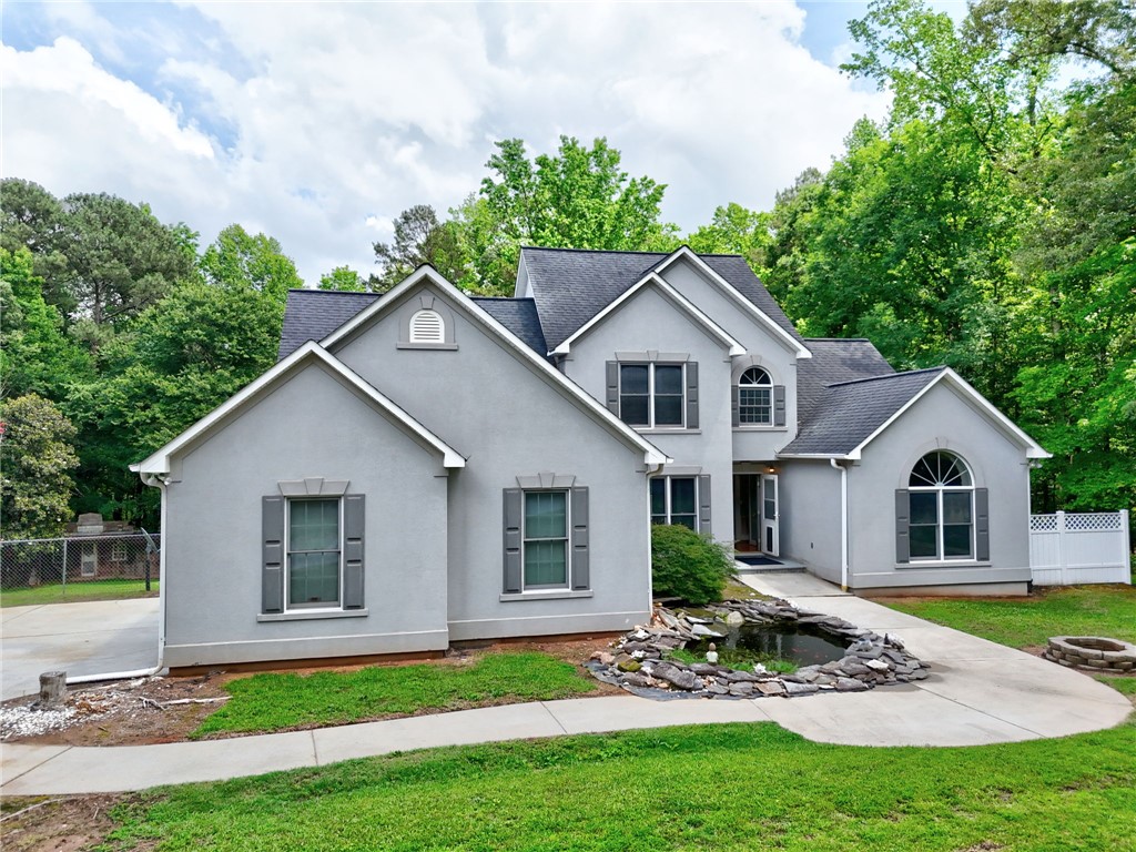 1016 Campbell Road Belton, SC 29627 - Photo 2 of 50 A graceful home with arched windows and a serene koi pond welcomes you to verdant surroundings.