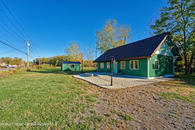 a house with green field in front of it