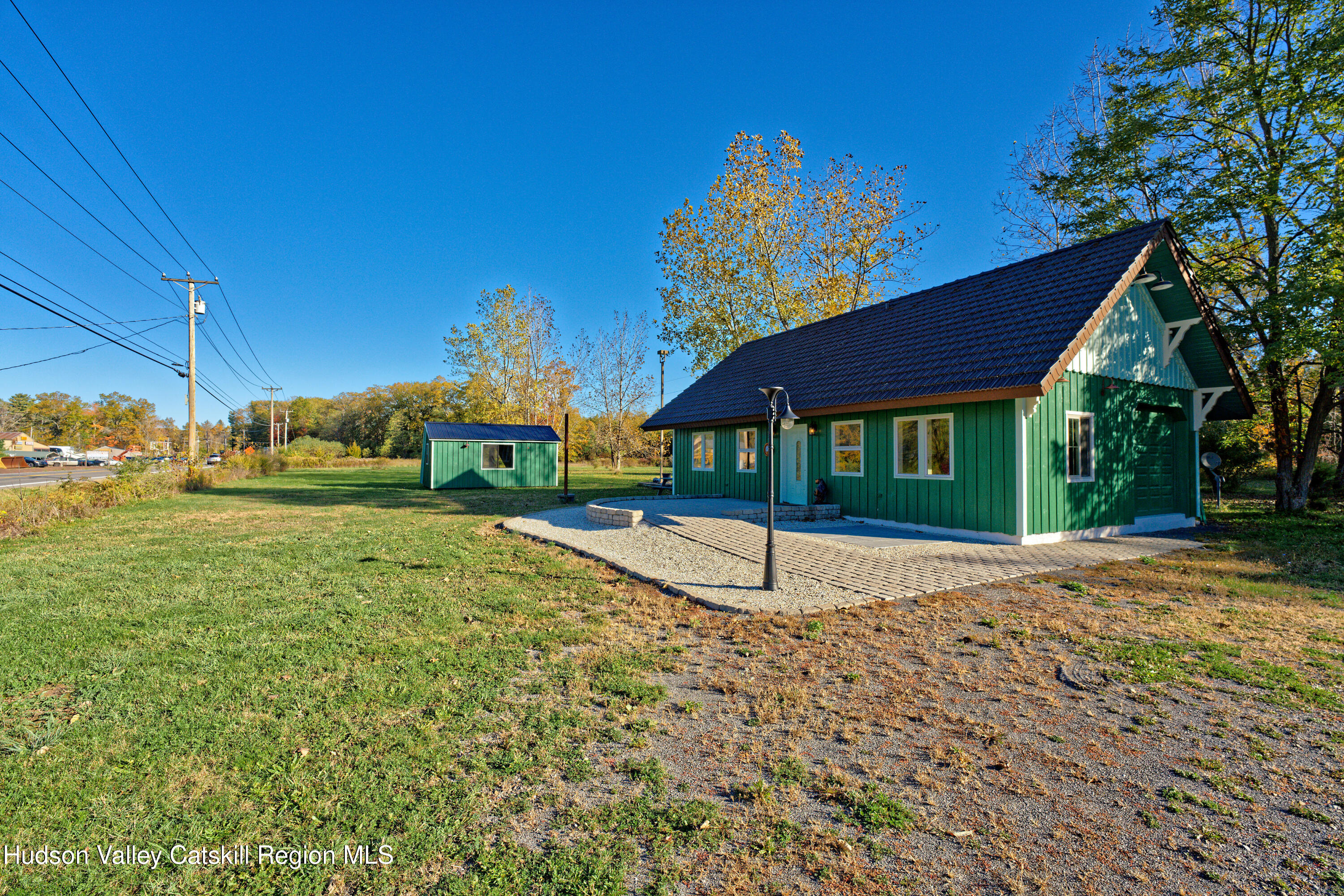 a house with green field in front of it