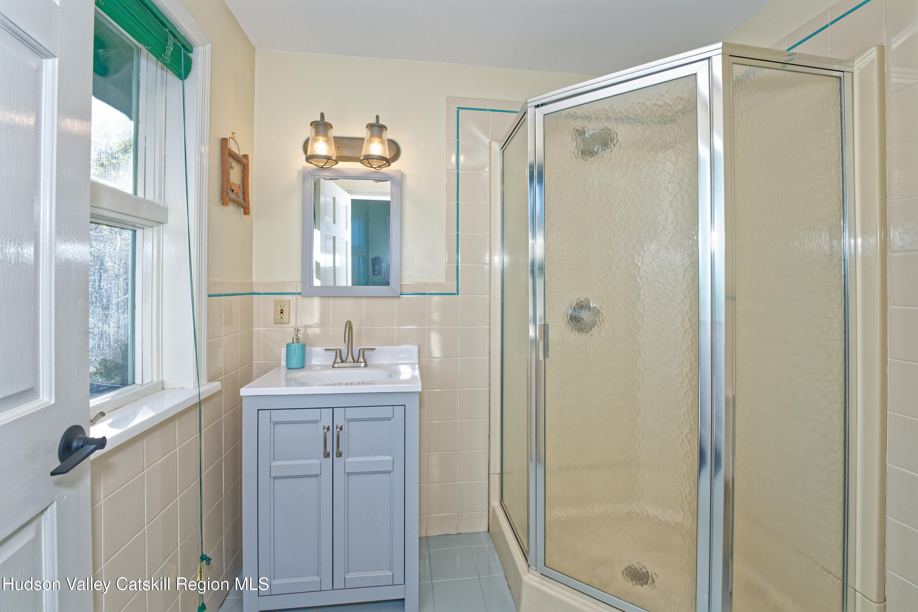 7426 Highway 32 Cairo, NY 12413 - Photo 13 of 49 a bathroom with a double vanity sink mirror and shower