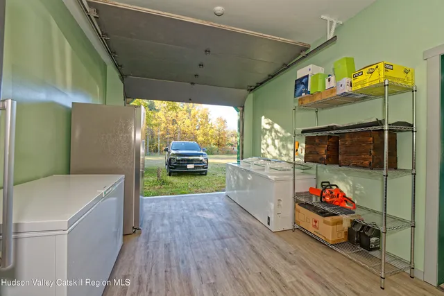 a living room with furniture a wooden floor and next to a window