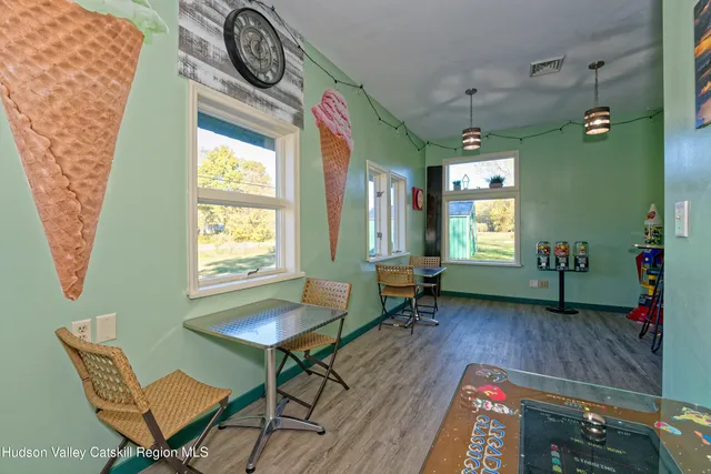 a view of a room with furniture and a window