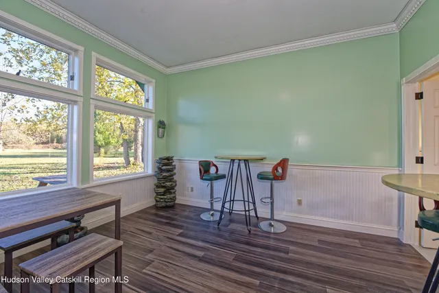 a view of a room with wooden floor and windows
