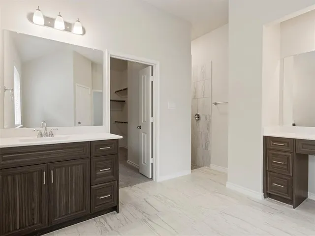 a spacious bathroom with a double vanity sink double and mirror