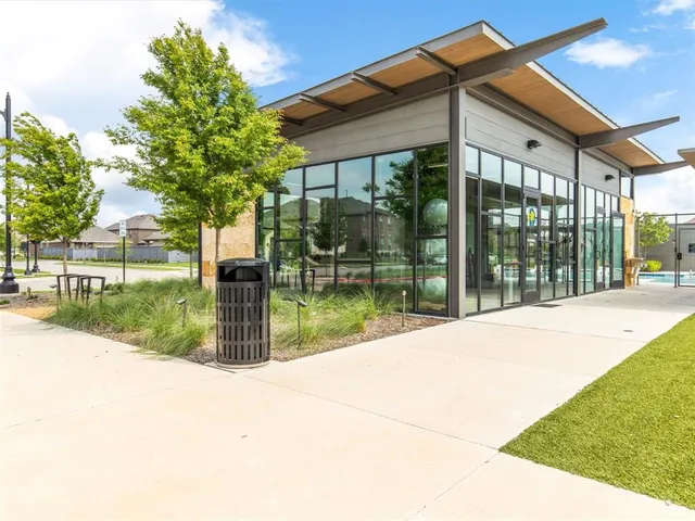 a view of a house with a swimming pool and a yard