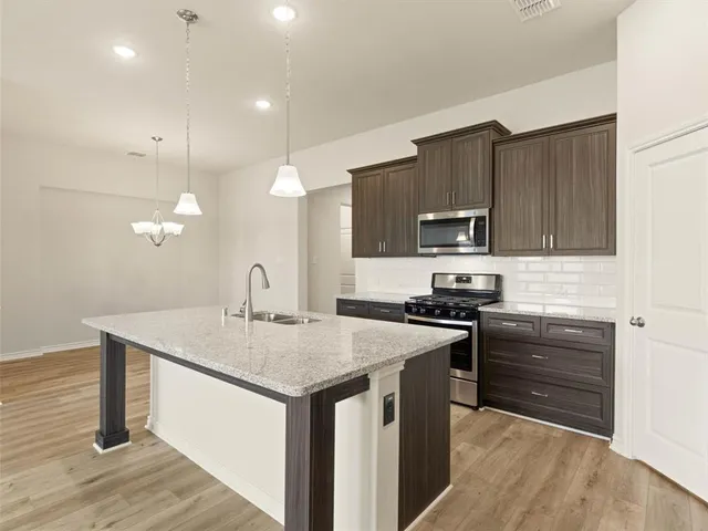 a kitchen that has a sink and a stove in it