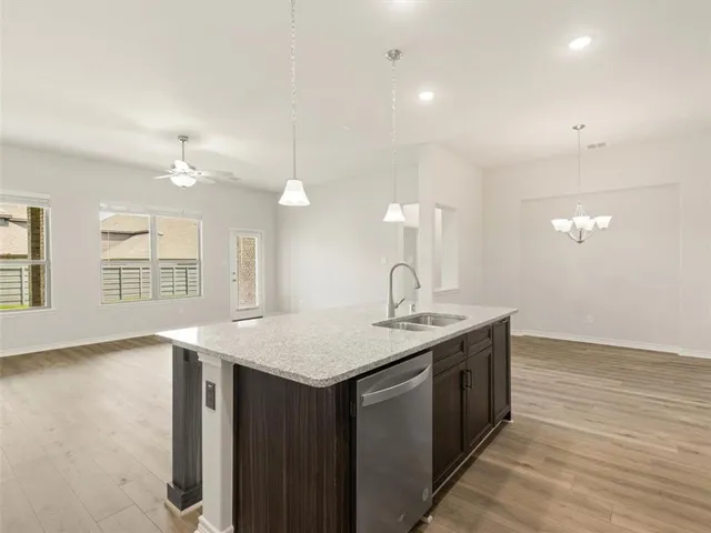 a kitchen with a sink vanity and a mirror