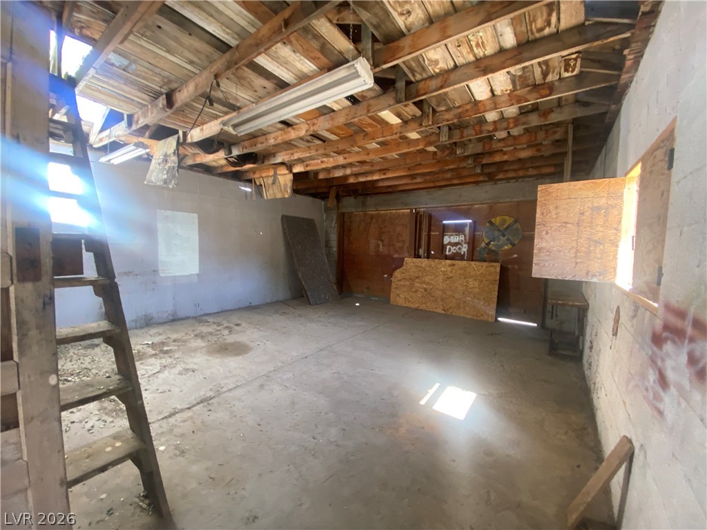 701 3rd Street Gabbs, NV 89409 - Photo 10 of 10 Unfinished storage space with exposed ceiling beams and abundant natural light offers future possibilities.