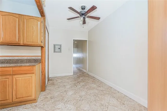 an empty room with closet and a hallway