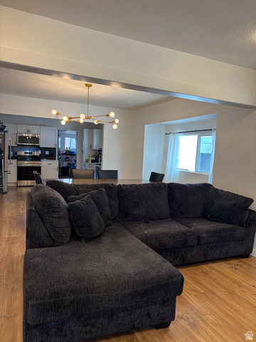 545 23rd Street Ogden, UT 84401 - Photo 24 of 28 Open-concept living area featuring wood-finish flooring, a modern sputnik chandelier, and recessed lighting