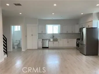 a kitchen with stainless steel appliances a refrigerator and a stove top oven